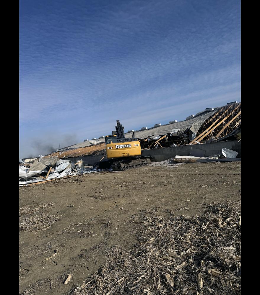 An excavator pulls the roof back to allow Luverne firefighters to extinguish the fire that started Jan. 20 at the finishing barn located in Section 18 of Magnolia Township. Firefighters returned to the facility four times over the past week as roof insulation continued to smolder.